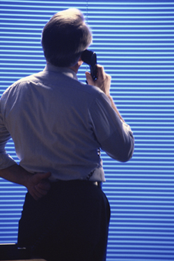 Guy Standing In Front of Blinds